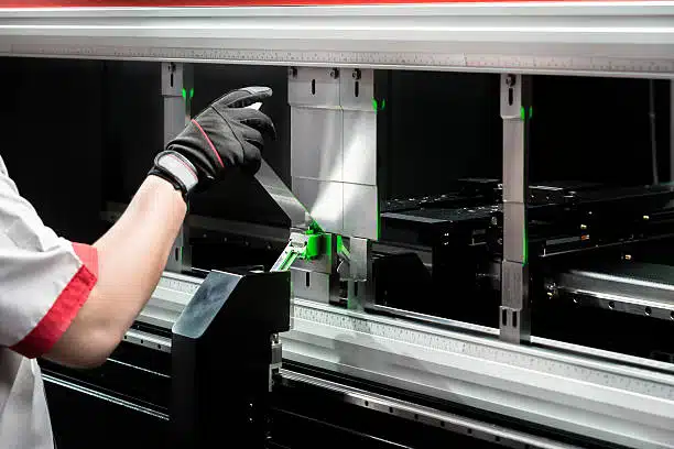 Workers are using modernized equipment for metal bending processing, China metal stamping supplier strict quality control and efficient production process.